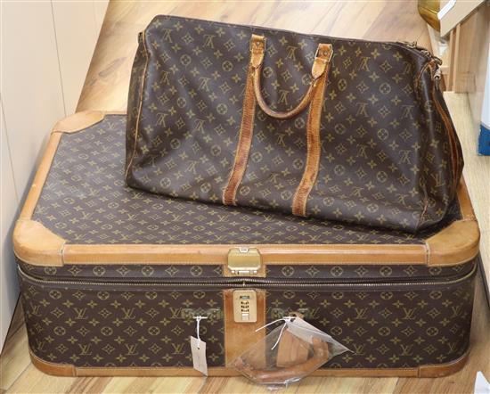A Louis Vuitton suitcase and holdall